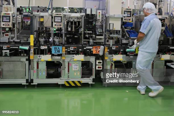 An employee assembles motor control units on the production line of Jtekt Corp's Hanazono plant in Okazaki, Aichi Prefecture, Japan, on Tuesday, July...