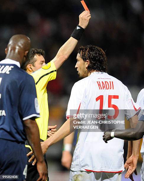 The referee Christian Guillard gives a red card to Nancy's Moroccan forward Youssouf Hadji during the French L1 football match Nancy vs Valenciennes...