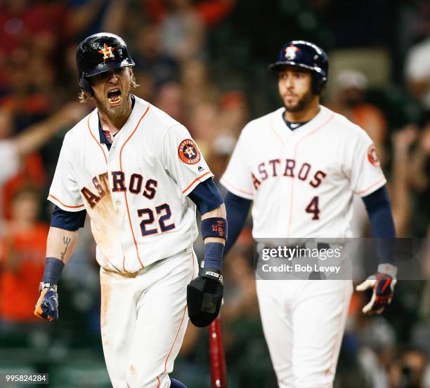 Josh Reddick of the Houston Astros reacts after scoring in the eleventh inning against the Oakland Athletics at Minute Maid Park on July 10, 2018 in...