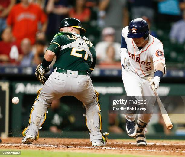 Alex Bregman of the Houston Astros hits ground ball to the catcher in the eleventh inning allowing Kyle Tucker on a throwing error by Jonathan Lucroy...