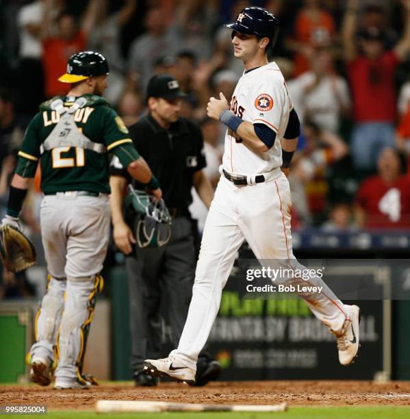 Kyle Tucker of the Houston Astros scores the winning run in the eleventh inning on a soft single by Alex Bregman at Minute Maid Park on July 10, 2018...