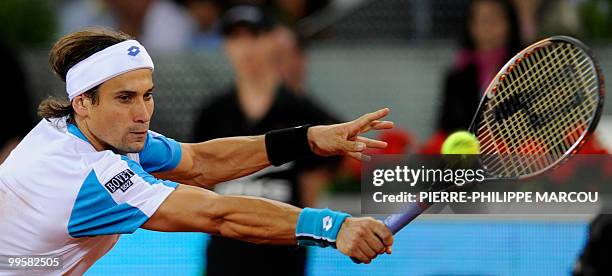 Spanish David Ferrer returns a ball against Swiss Roger Federer during their match of the Madrid Masters on May 15, 2010 at the Caja Magic sports...