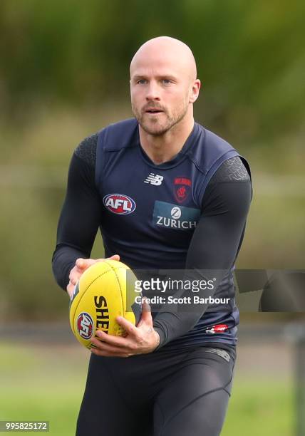 Nathan Jones of the Demons runs with the ball during a Melbourne Demons AFL training session at Gosch's Paddock on July 11, 2018 in Melbourne,...