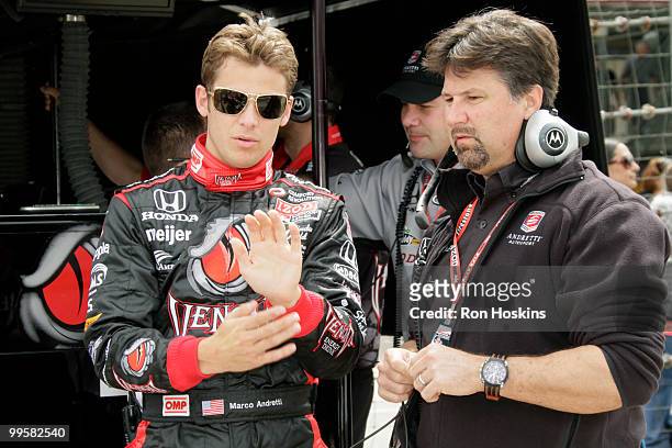 Marco Andretti of Andretti Autosport talks with his father, Michael Andretti during opening day at the Indianapolis Motor Speedway on May 15, 2010 in...