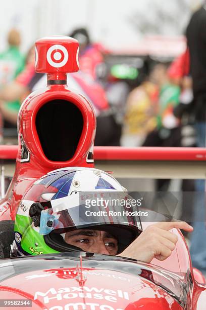 Dario Franchitti of Target Chip Ganassi Racing motions to a crew member during opening day at the Indianapolis Motor Speedway on May 15, 2010 in...