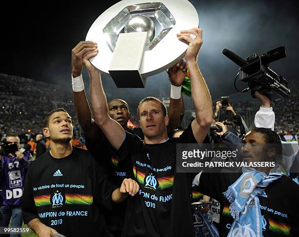 Marseille's players Hatem Ben Arfa take , Benoit Cheyrou and Baki Kone celebrate their French L1 title the end of the French L1 football match...