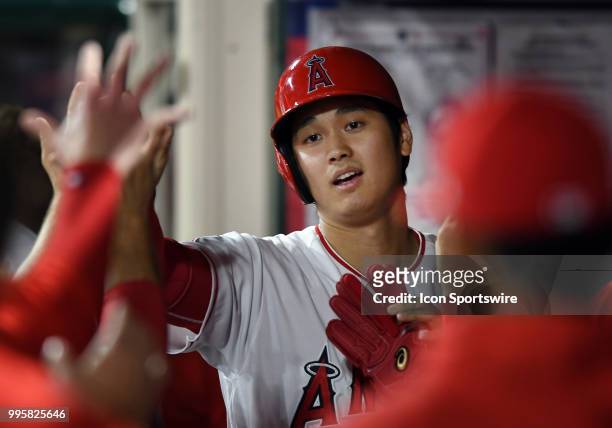 Los Angeles Angels of Anaheim designated hitter Shohei Ohtani in the dugout after scoring from second on an Angels hit in the fourth inning of a game...