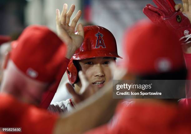 Los Angeles Angels of Anaheim designated hitter Shohei Ohtani in the dugout after scoring from second on an Angels hit in the fourth inning of a game...