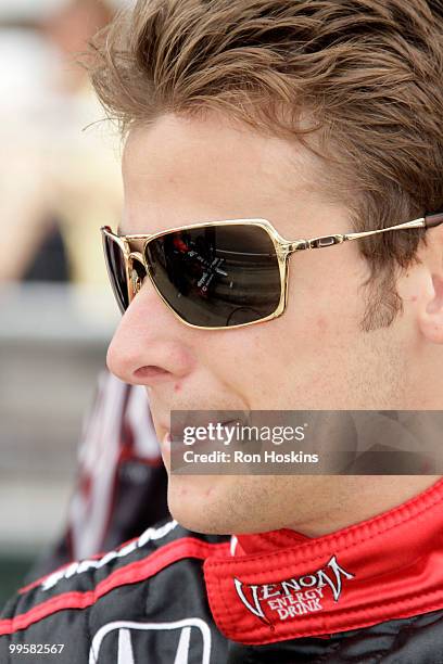 Marco Andretti of Andretti Autosport waits as his crew readies his car during opening day at the Indianapolis Motor Speedway on May 15, 2010 in...