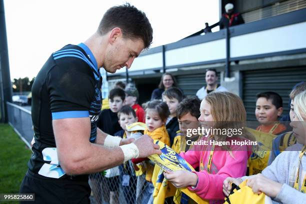 Beauden Barrett signs autographs for fans during a Hurricanes Super Rugby training session at Rugby League Park on July 11, 2018 in Wellington, New...