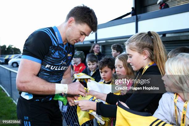 Beauden Barrett signs autographs for fans during a Hurricanes Super Rugby training session at Rugby League Park on July 11, 2018 in Wellington, New...