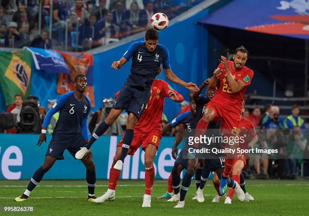 Marouane Fellaini of Belgium competes for the ball with Raphael Varane of France during the 2018 FIFA World Cup Russia Semi Final match between...