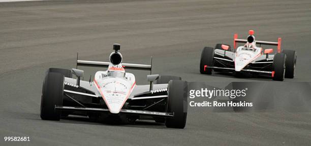 Helio Castroneves of Team Penske shows his teammate Will Power the away around the Indianapolis Motor Speedway during opening day at the Indianapolis...