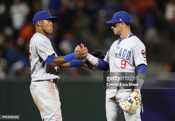 Addison Russell shakes hands with Javier Baez of the Chicago Cubs after they beat the San Francisco Giants at AT&T Park on July 10, 2018 in San...