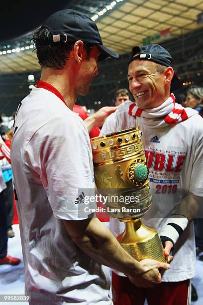 Mark van Bommel and Arjen Robben of Bayern Muenchen celebrate following their team's victory at the end of the DFB Cup final match between SV Werder...