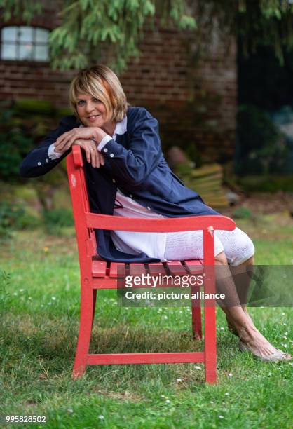 June 2018, Germany, Buechten: The presenter Alida Gundlach sits on a bench in her garden. Gundlach celebrates her 75th birthday on 17 July. Photo:...