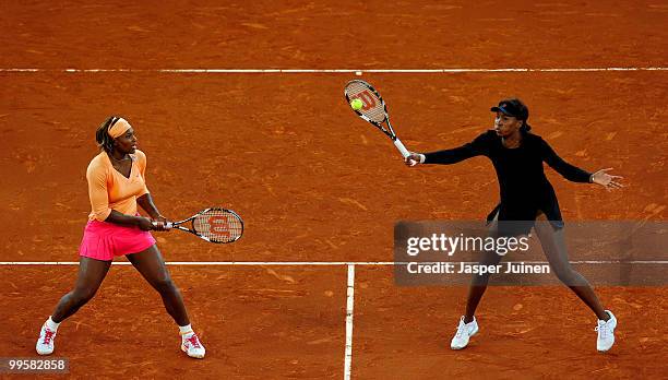 Venus Williams of the USA plays a backhand with her sister Serena Williams in their final doubles match against Gisela Dulko of Argentina and Flavia...