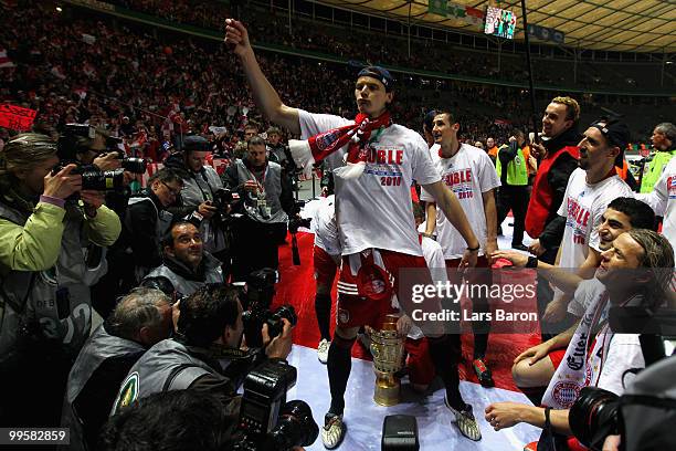 Daniel van Buyten of Bayern Muenchen celebrates with his team mates following their team's victory at the end of the DFB Cup final match between SV...