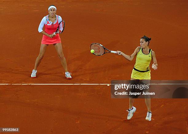 Flavia Pennetta of Italy jumps to play a backhand with her doubles partner Gisela Dulko of Argentina during their final doubles match against Venus...