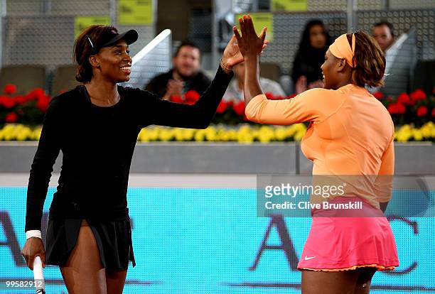 Venus Williams and Serena Williams of the USA celebrate match point against Gisela Dulko of Argentina and Flavia Pannetta of Italy in womens doubles...