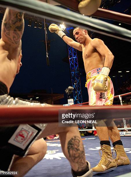 James Degale MBE looks down at Sam Horton during a fight for the vacant WBA International Super-Middleweight championship belt at the West Ham...