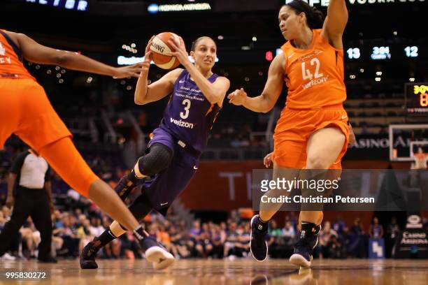 Diana Taurasi of the Phoenix Mercury drives the ball past Brionna Jones of the Connecticut Sun during the first half of WNBA game at Talking Stick...