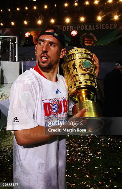 Franck Ribery of Bayern presents the trophy after winning the DFB Cup final match between SV Werder Bremen and FC Bayern Muenchen at Olympic Stadium...