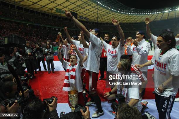 Players of Bayern Muenchen celebrate following their team's victory at the end of the DFB Cup final match between SV Werder Bremen and FC Bayern...