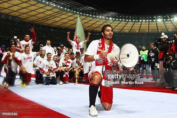 Hamit Altintop of Bayern speaks to the fans with a megaphone after winning the DFB Cup final match between SV Werder Bremen and FC Bayern Muenchen at...