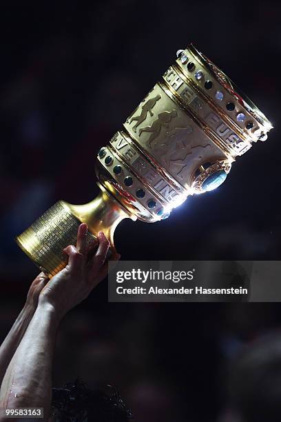 The DFB cup trophy is raised after the DFB Cup final match between SV Werder Bremen and FC Bayern Muenchen at Olympic Stadium on May 15, 2010 in...