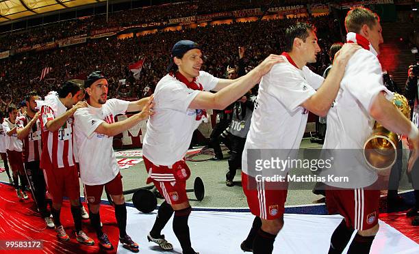 Franck Ribery, Daniel van Buyten, Miroslav Klose and Bastian Schweinsteiger celebrate after winning the DFB Cup final match between SV Werder Bremen...