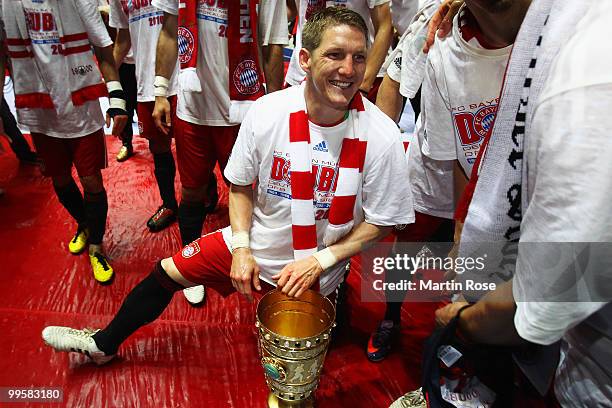 Bastian Schweinsteiger celebrates with the trophy after winning the DFB Cup final match between SV Werder Bremen and FC Bayern Muenchen at Olympic...