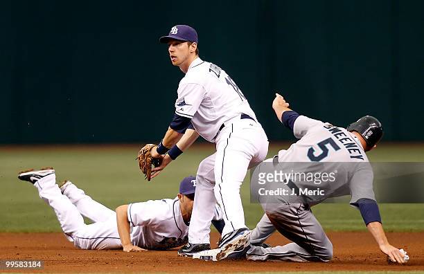Shortstop Jason Bartlett of the Tampa Bay Rays flips the ball to second baseman Ben Zobrist for an out as designated hitter Mike Sweeney of the...