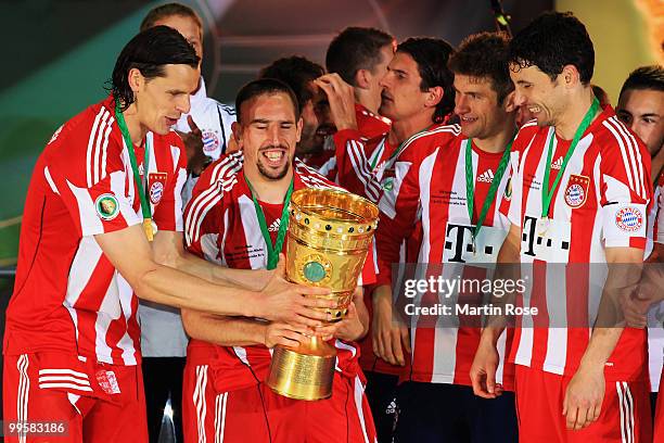 Franck Ribery of Bayern Muenchen celebrates with the DFB Cup trophy following their victory at the end of the DFB Cup final match between SV Werder...