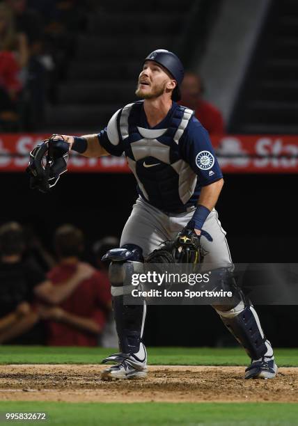 Seattle Mariners catcher Chris Herrmann watches a pop fly in the sixth inning of a game against the Los Angeles Angels of Anaheim played on July 10,...