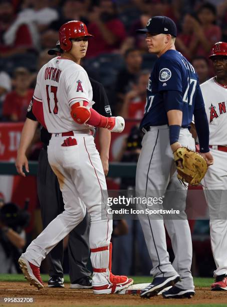 Los Angeles Angels of Anaheim designated hitter Shohei Ohtani gets a single and stands at first base with Seattle Mariners first baseman Ryon Healy...