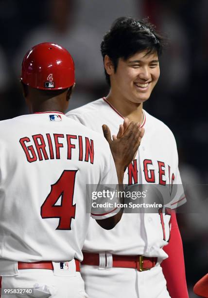 Los Angeles Angels of Anaheim designated hitter Shohei Ohtani with first base coach Alfredo Griffin on the field after the Angels defeated the...