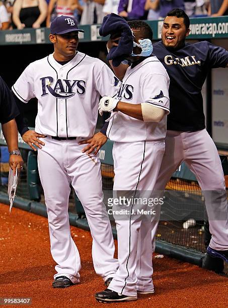 Catcher Dioner Navarro hits infielder Willy Aybar of the Tampa Bay Rays with shaving cream as infielder Carlos Pena looks on after Aybar hit a bottom...