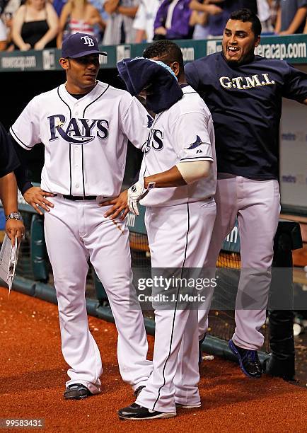 Catcher Dioner Navarro hits infielder Willy Aybar of the Tampa Bay Rays with shaving cream as infielder Carlos Pena looks on after Aybar hit a bottom...