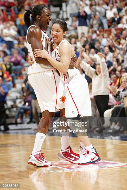 Tina Charles congratulates Kara Lawson of the Connecticut Sun on her three-quarter court basket at the first half buzzer against the Chicago Sky on...