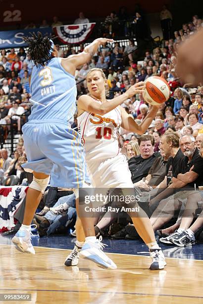 Anete Jekabsone-Zogota of the Connecticut Sun passes under Dominique Canty of the Chicago Sky on May 15, 2010 at Mohegan Sun Arena in Uncasville,...