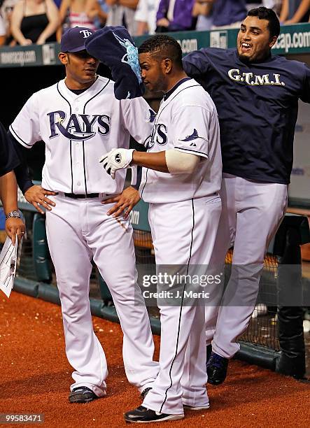 Catcher Dioner Navarro hits infielder Willy Aybar of the Tampa Bay Rays with shaving cream as infielder Carlos Pena looks on after Aybar hit a bottom...