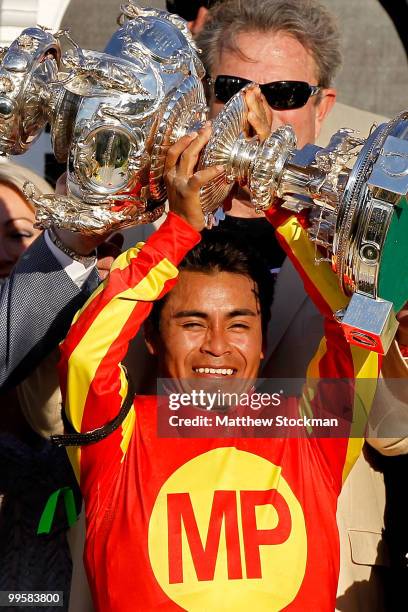 Jockey Martin Garcia celebrates in the winners circle after riding Lookin at Lucky to win during the 135th Preakness Stakes at Pimlico Race Course on...