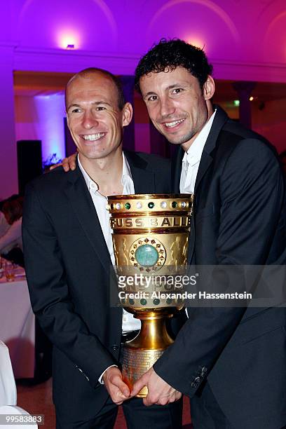Arjen Robben and Mark van Bommel pose with the trophy during the Bayern Muenchen Champions Party after the DFB Cup Final match against Werder Bremen...