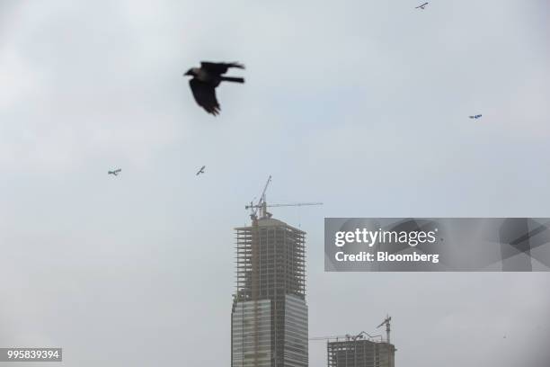 Cranes operate at a construction site at Clifton Beach in Karachi, Pakistan, on Monday, July 9, 2018. The Pakistan economy is in distress. How else...