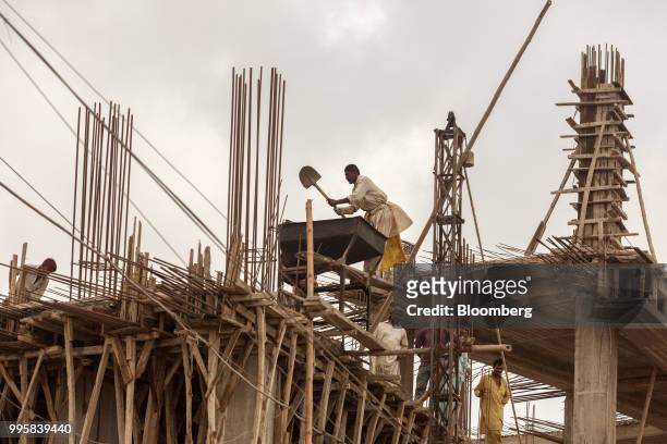 Workers labor at a construction site in Karachi, Pakistan, on Monday, July 9, 2018. The Pakistan economy is in distress. How else to describe an...