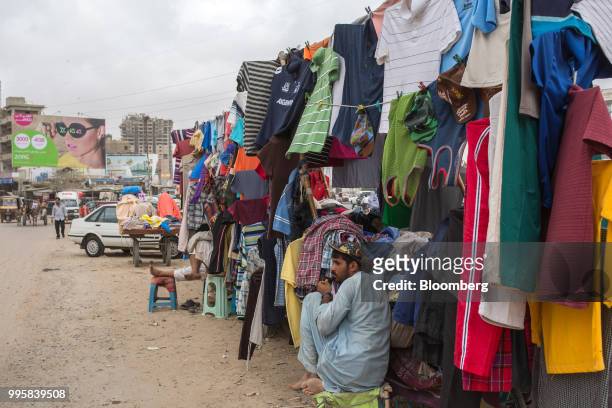 Vendor waits for customers at a street clothing stall in Karachi, Pakistan, on Monday, July 9, 2018. The Pakistan economy is in distress. How else to...