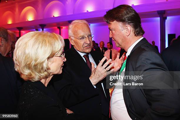 Head coach Louis van Gaal talks to Edmund Stoiber and his wife Karin attend the Bayern Muenchen Champions Party after the DFB Cup Final match against...