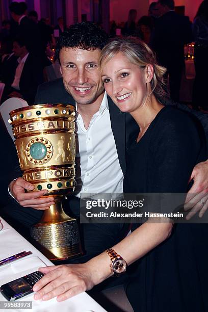 Mark van Bommel and his wife Andra pose with the trophy during the Bayern Muenchen Champions Party after the DFB Cup Final match against Werder...