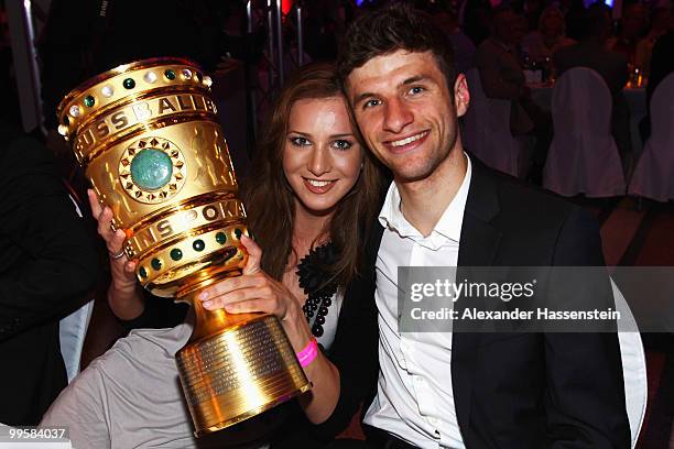 Thomas Mueller and his wife Lisa pose with the trophy during the Bayern Muenchen Champions Party after the DFB Cup Final match against Werder Bremen...